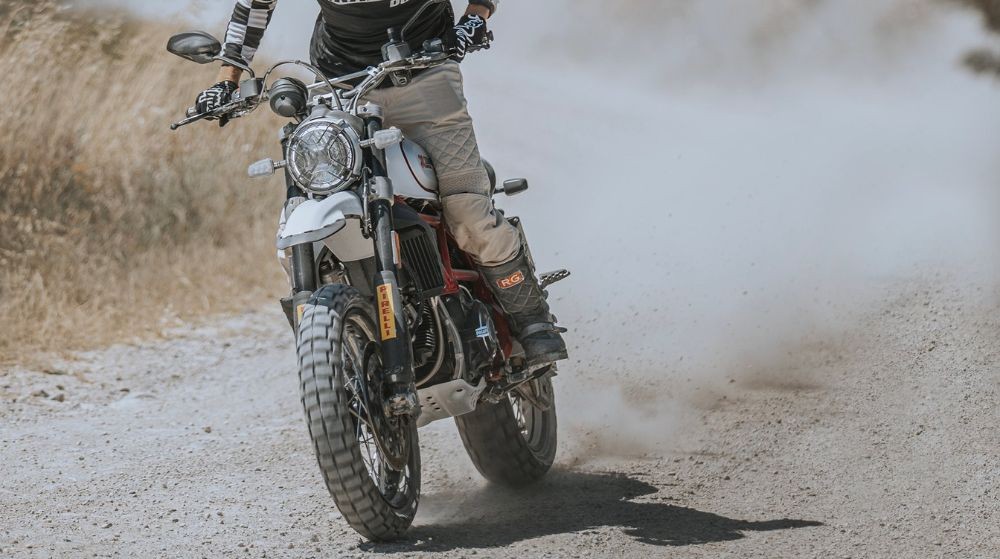 Motorcycle riding on dirt equipped with Pirelli Scorpion Rally STR tires