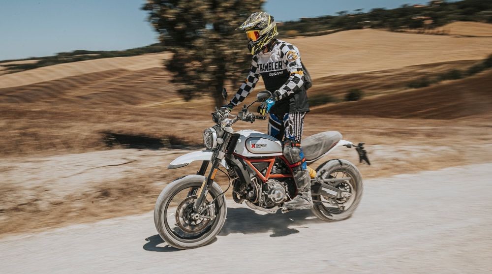 Ducati Scrambler with Pirelli Scorpion Rally STR tires on gravel road