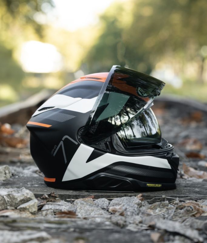 HJC RPHA 71 helmet close-up with visor open, showing lightweight composite shell and integrated sun visor design.