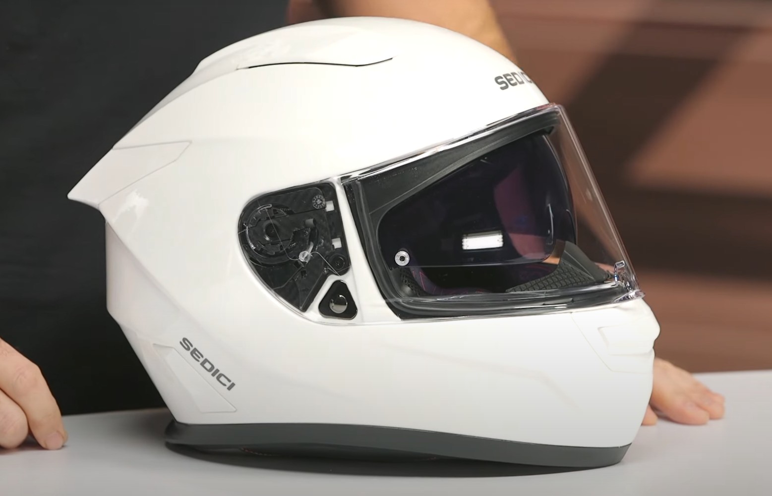Sedici Strada 3 helmet close-up, showing visor and shell design with multiple intake and exhaust vents for cooling airflow.
