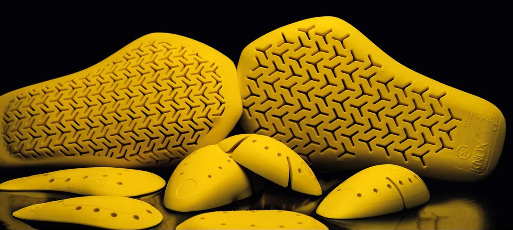 Knox Micro-Lock yellow viscoelastic armor pads that stay soft until impact and harden to absorb energy