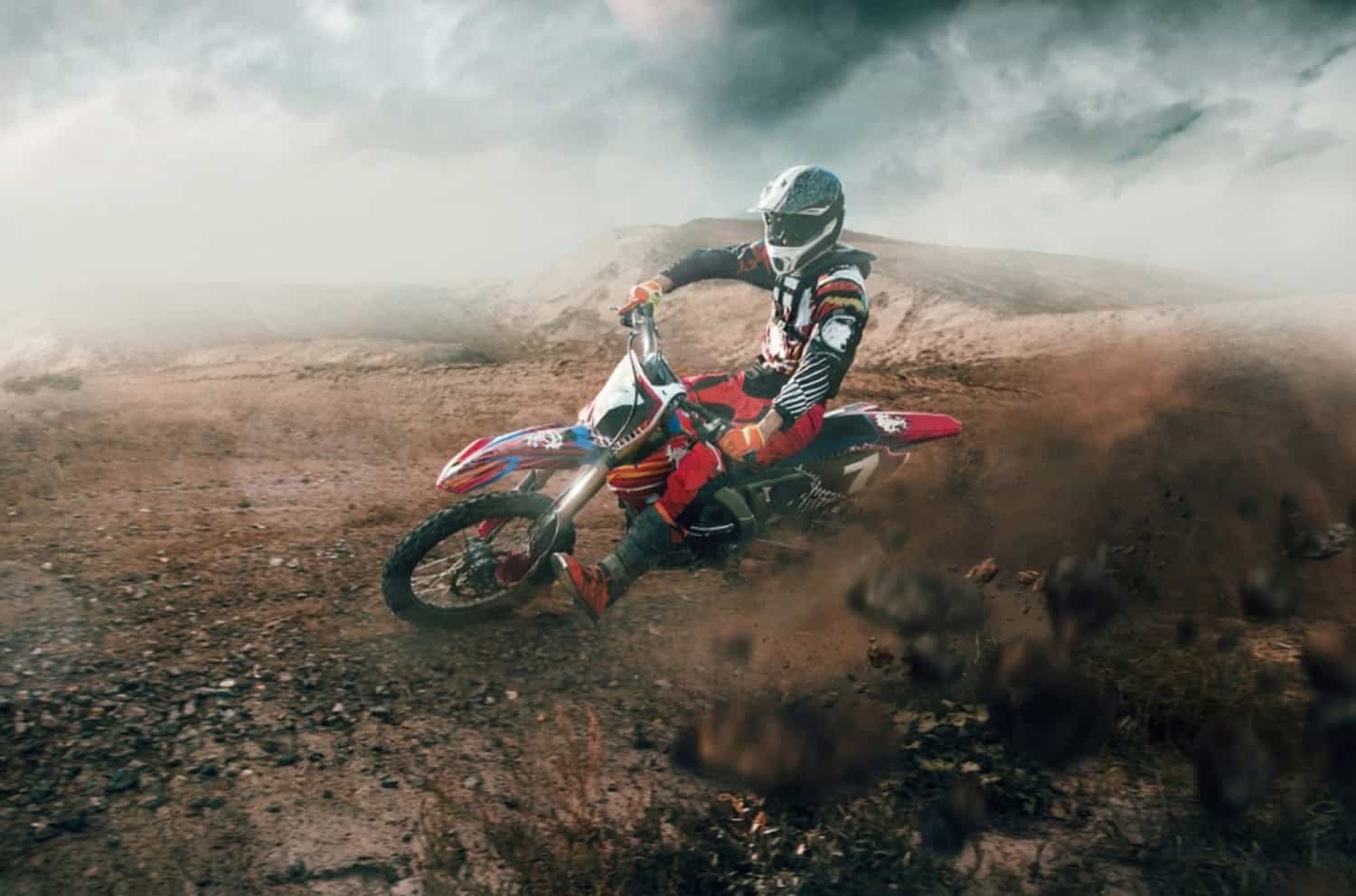 Motocross rider sliding on dirt track, showcasing power and endurance with Motul 7100 ester-based motorcycle oil