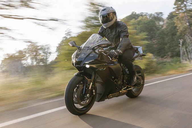Rider on a sportbike wearing HJC RPHA 71 helmet, designed with a full front-to-back ventilation system for airflow and fog reduction.