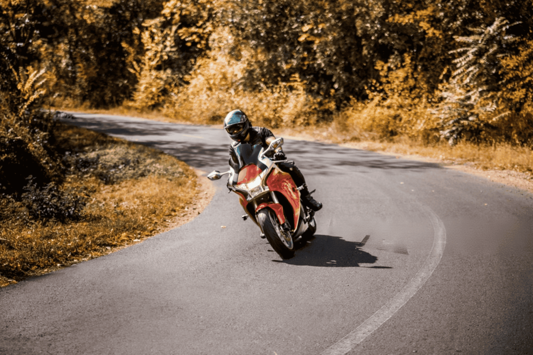 Rider leaning into a curve on a sport bike, showcasing agility and performance with Castrol Power1 protection
