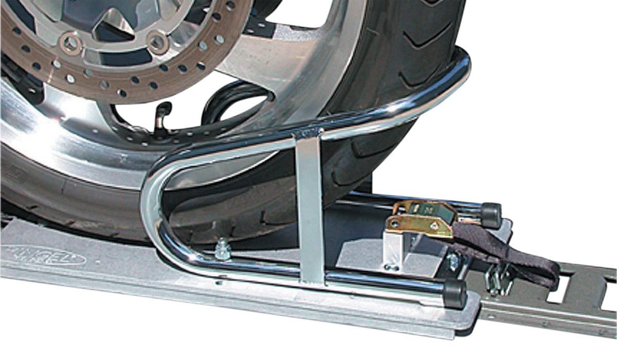 Close-up of a motorcycle tire secured in a Pingel Series E-Track Wheel Chock mounted on a trailer’s E-track rail.