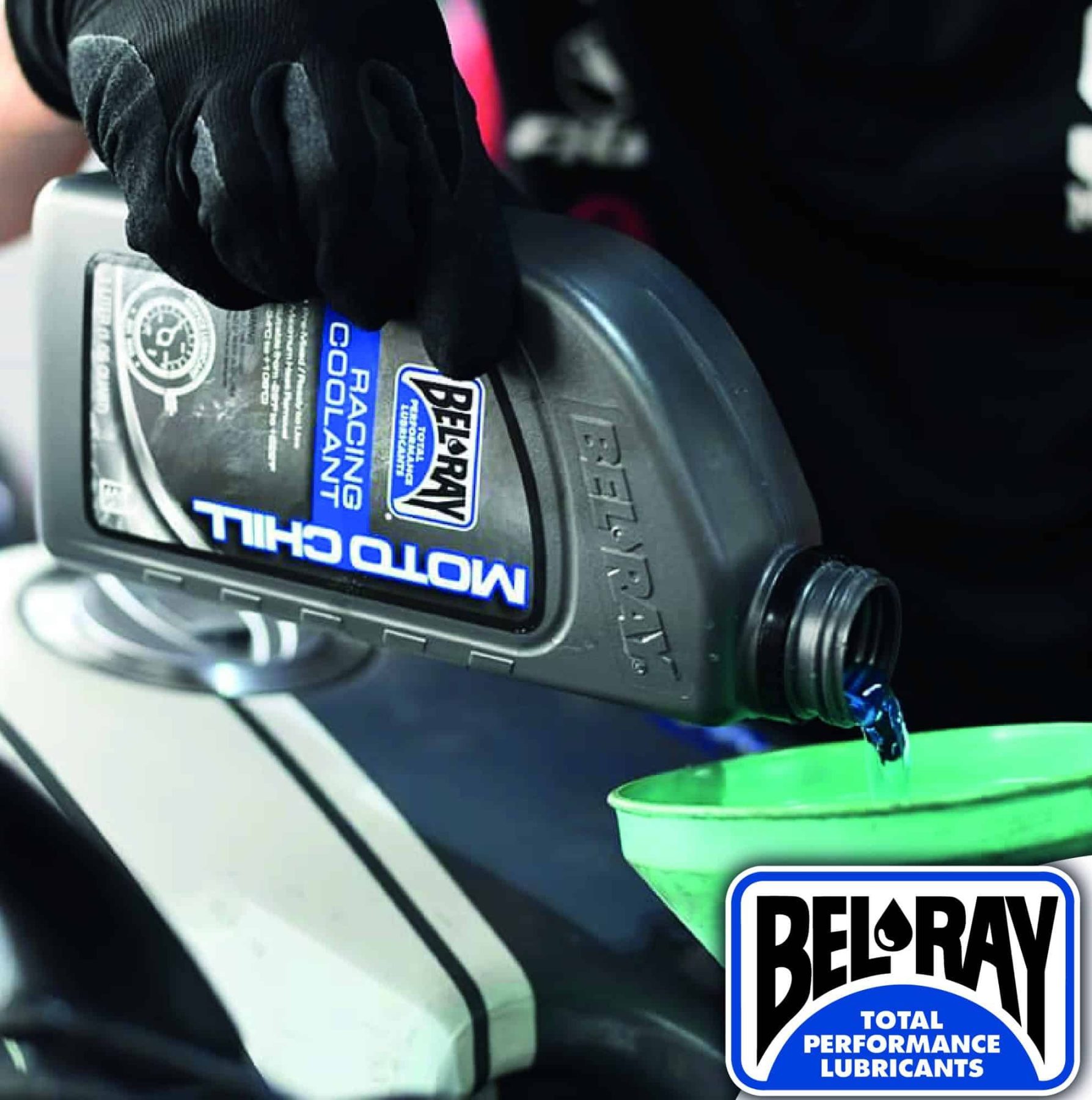 Mechanic pouring Bel-Ray Moto Chill Racing Coolant into motorcycle radiator with funnel