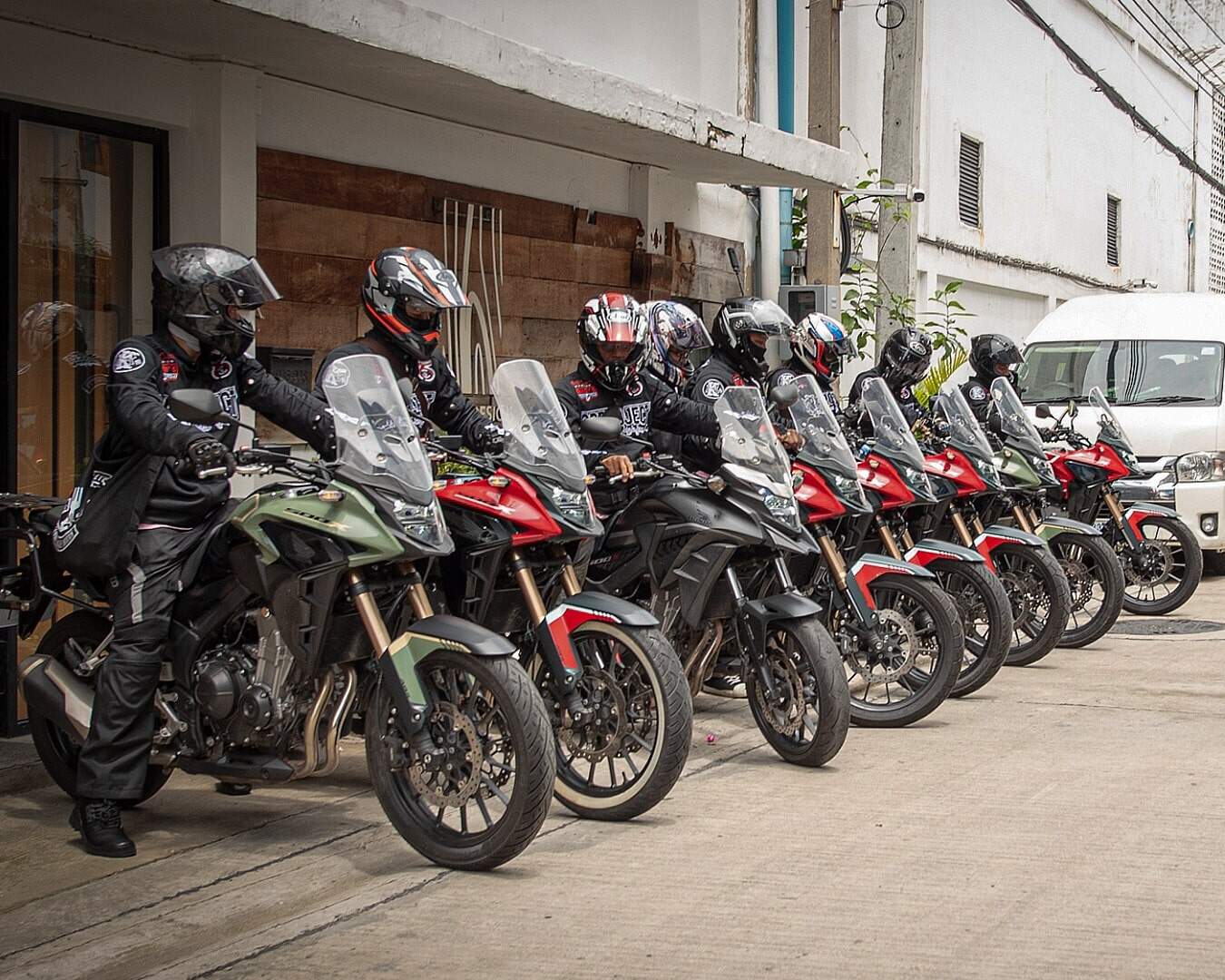 Riders on adventure motorcycles lined up outside Big Bike Rental Bangkok, ready for cross-country rides across Thailand and beyond