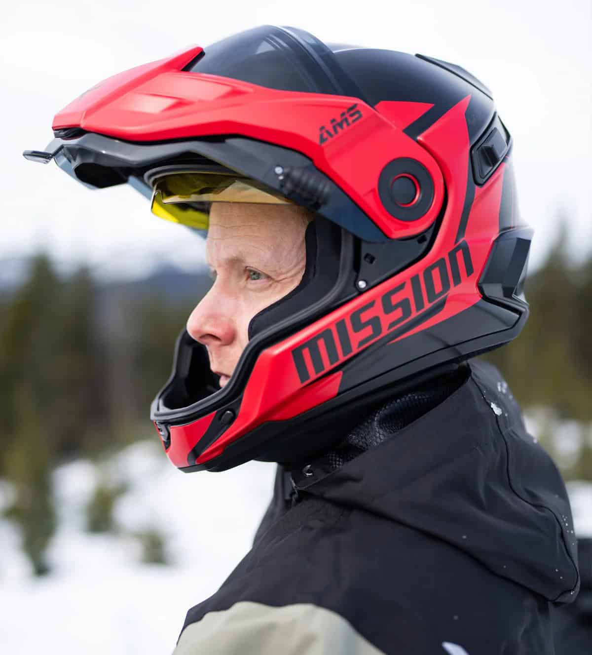 Side view of rider wearing CKX Mission AMS helmet with amber sun visor