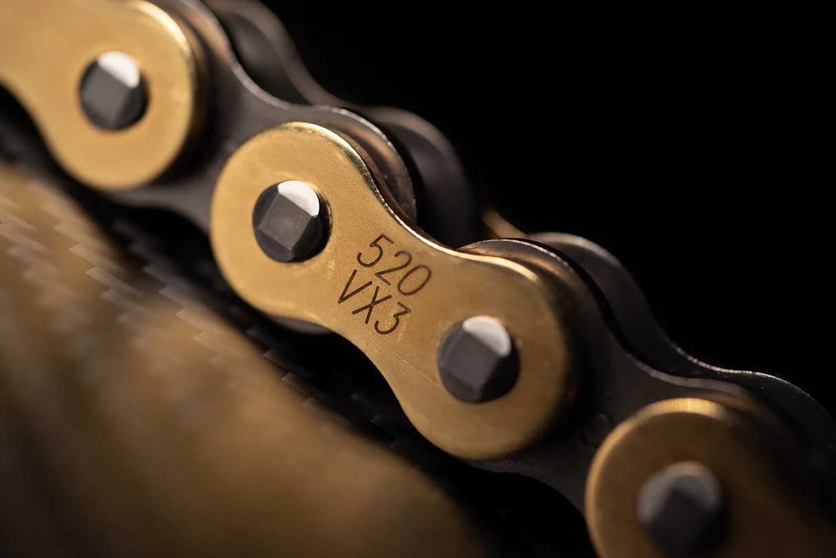 Close-up of D.I.D 520VX3 X-Ring motorcycle chain with gold side plates