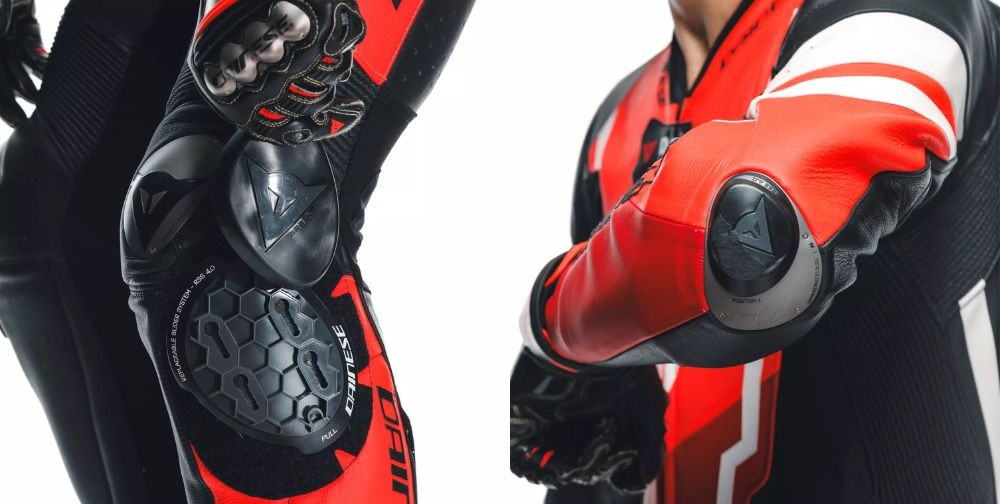 Close-up of a Dainese race suit showing replaceable knee and elbow sliders designed for track use and easy maintenance.