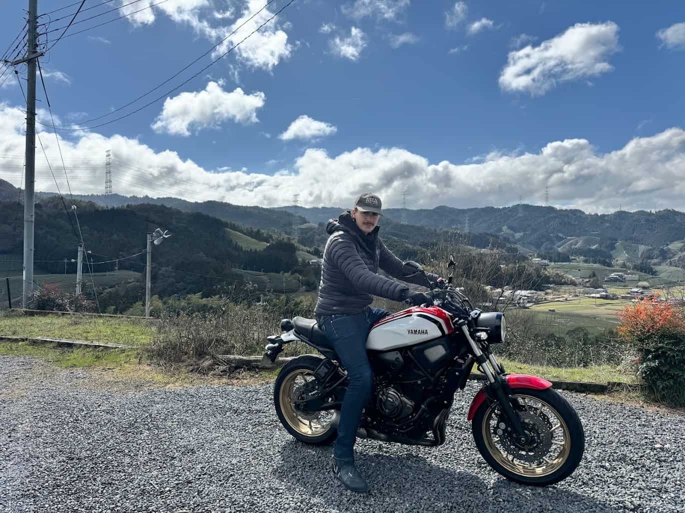 Rider on a Yamaha motorcycle in the countryside wearing ankle-height riding boots and jeans, showing urban street boot fit and style.