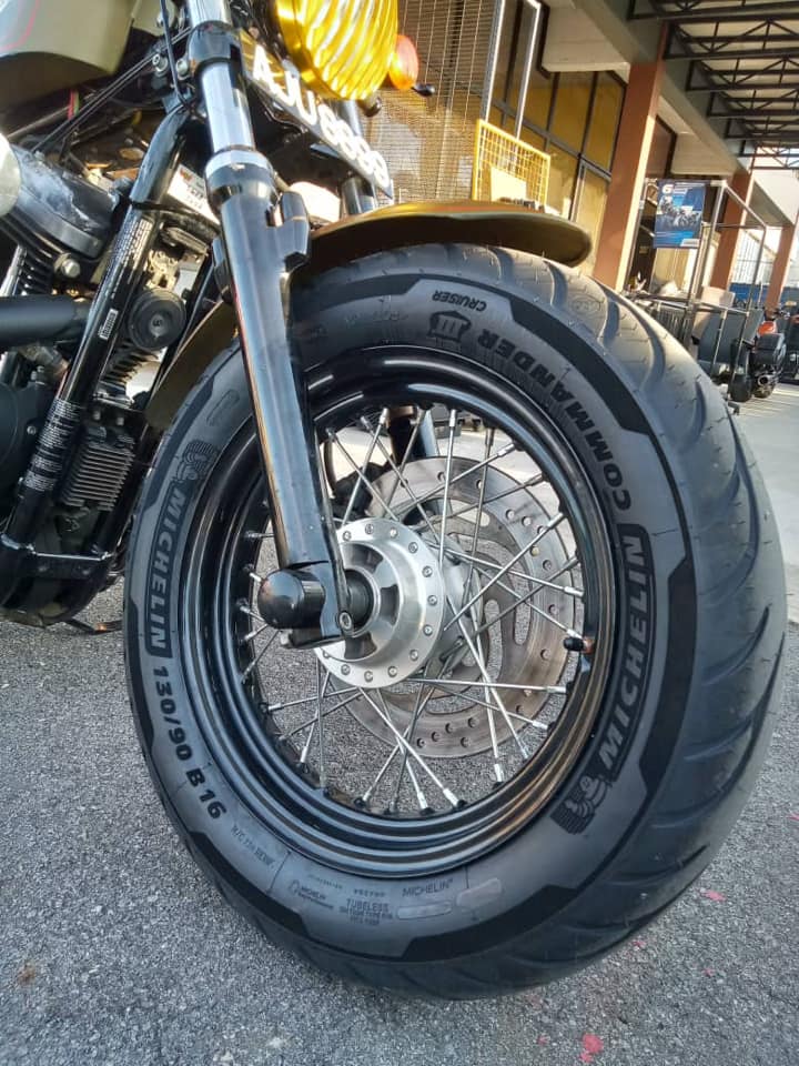 Close-up of a motorcycle front wheel fitted with Michelin Commander III Cruiser tire.