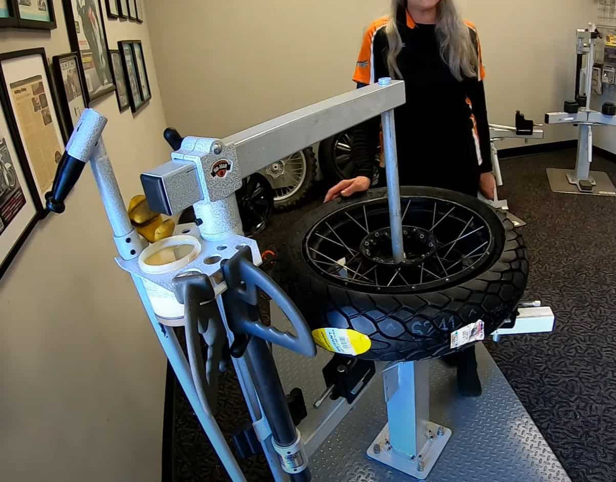 No-Mar Classic HD tire changer setup for motorcycle wheel mounting and bead breaking in a workshop.