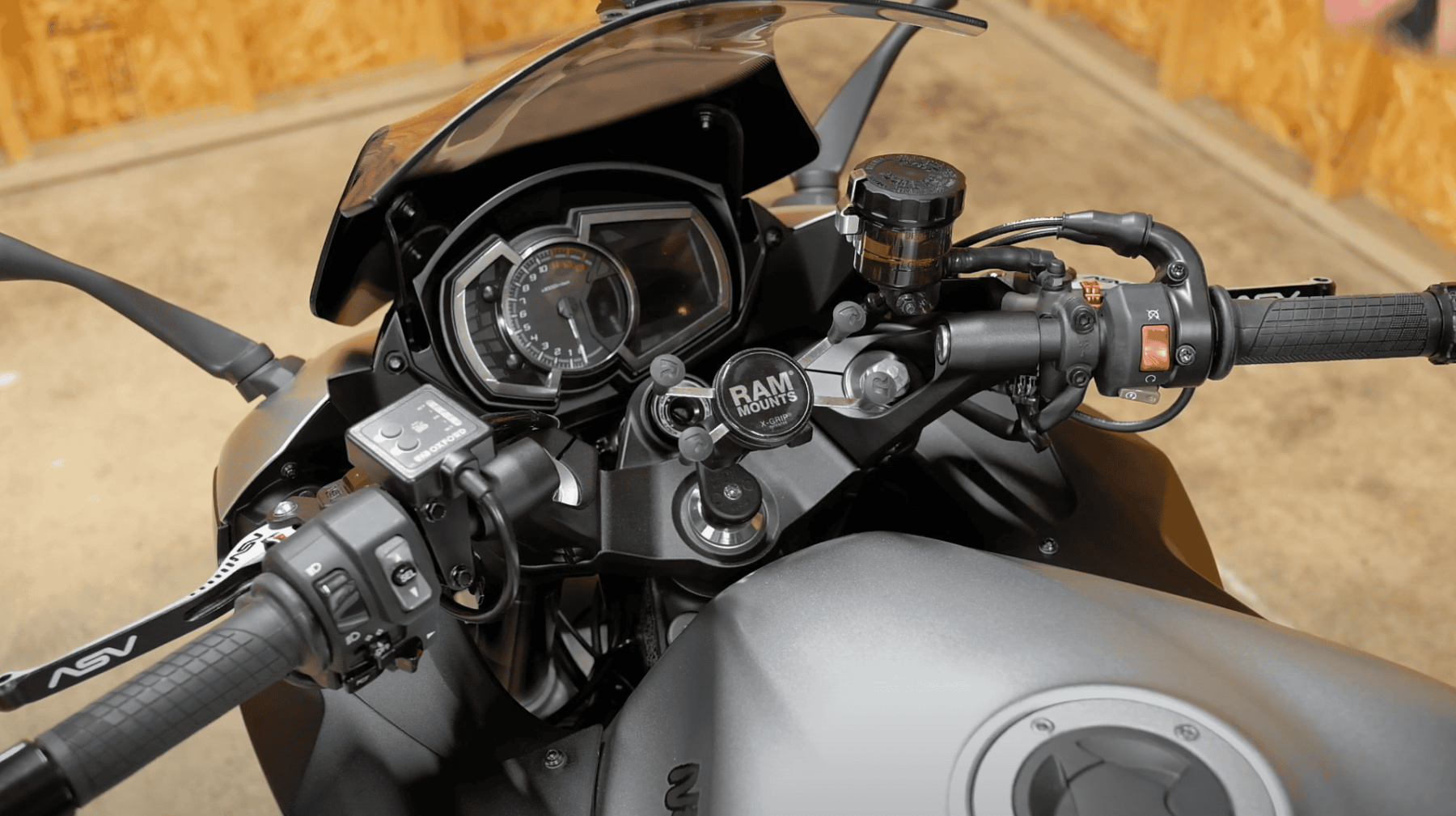 Close-up of Oxford Heaterz EVO Touring heated grips and controller installed on a sport-touring motorcycle handlebar.