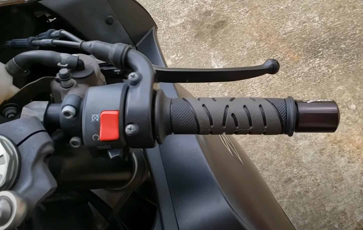 Close-up of Pro Grip 719 RVGS Gel Grips installed on a street bike handlebar, showing deep grooves and tacky texture.