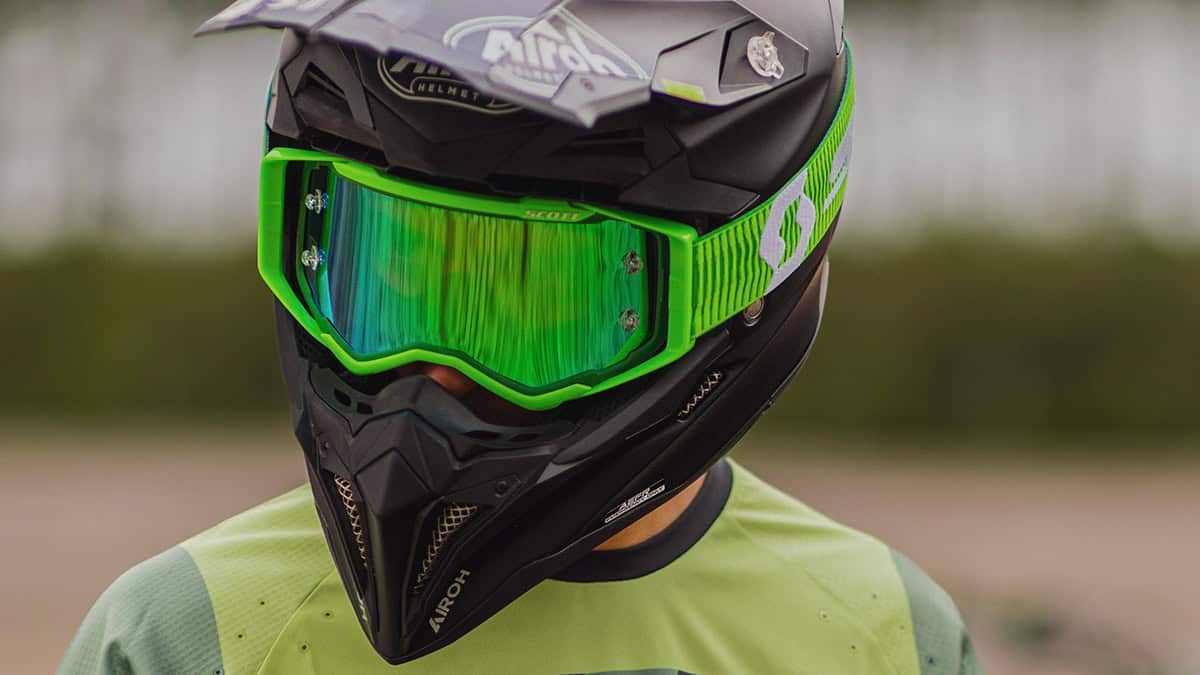 Motocross rider wearing Scott Prospect goggles with green mirrored lens and articulated outriggers