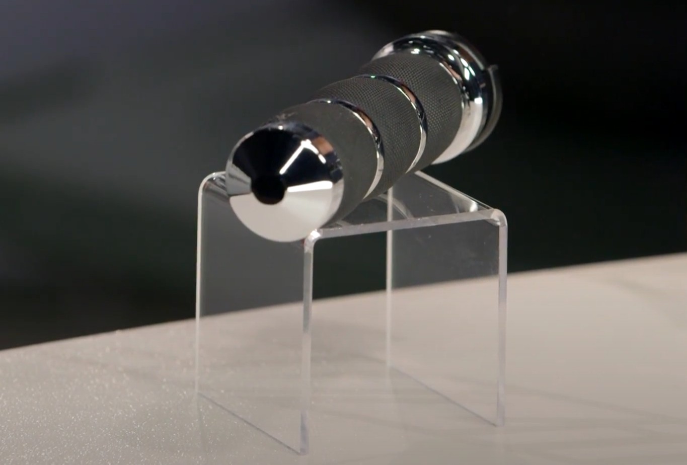 Close-up of Avon Air Cushion Smooth motorcycle grip with chrome ends and soft rubber surface on a display stand.