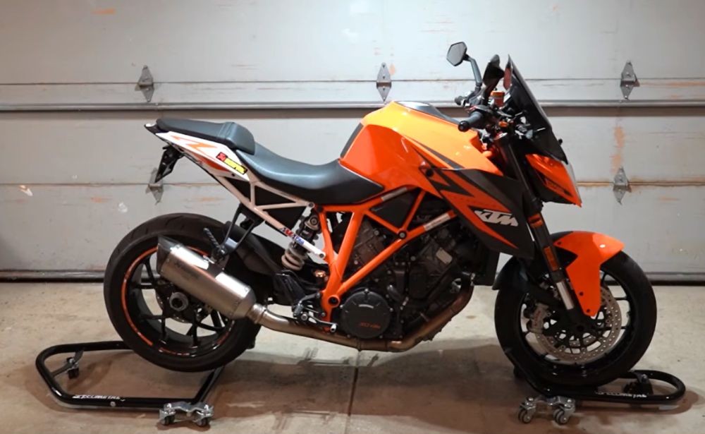 KTM motorcycle lifted by Speedmetal Rolling Front and Rear Stands in a garage