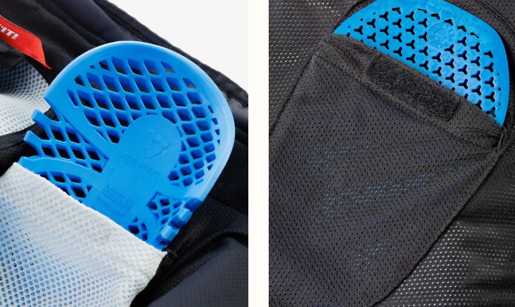 Close-up of blue CE-rated motorcycle armor pads inside mesh-lined protective pockets on riding pants.