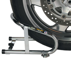 Motorcycle front wheel secured in a polished chrome Pingel Removable Wheel Chock mounted on a trailer floor.