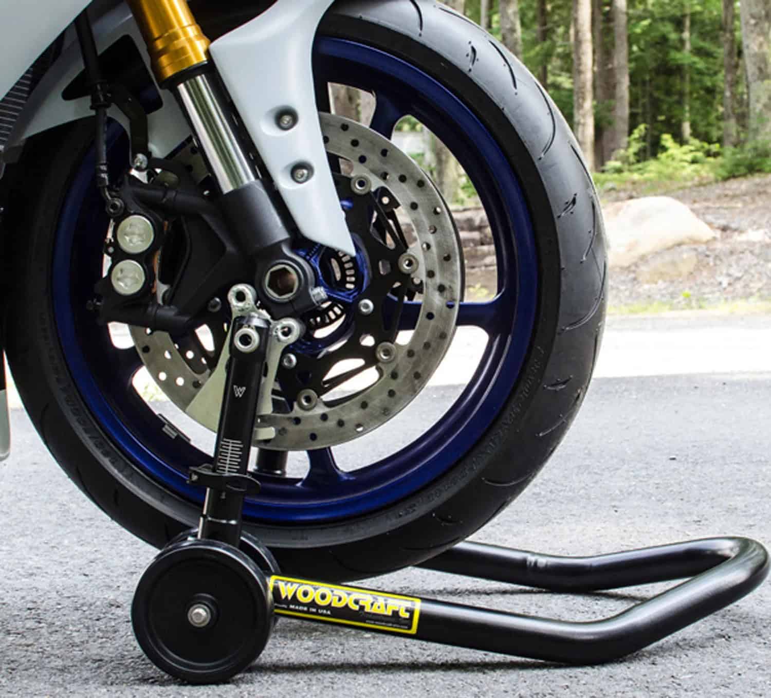 Woodcraft Adjustable Forklift Stand lifting a motorcycle’s front wheel for maintenance