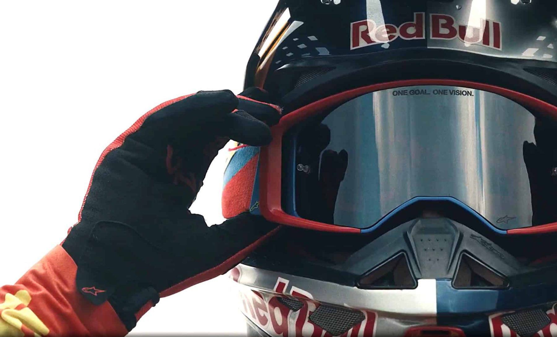 Motocross rider adjusting Alpinestars Vision 5 goggles with mirrored lens and precision fit