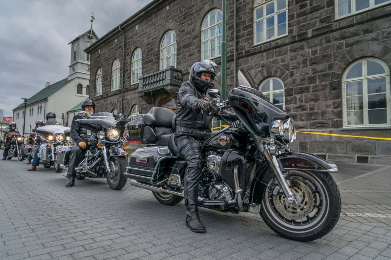 Group of Harley-Davidson touring riders on the street, showcasing seat height and riding posture differences