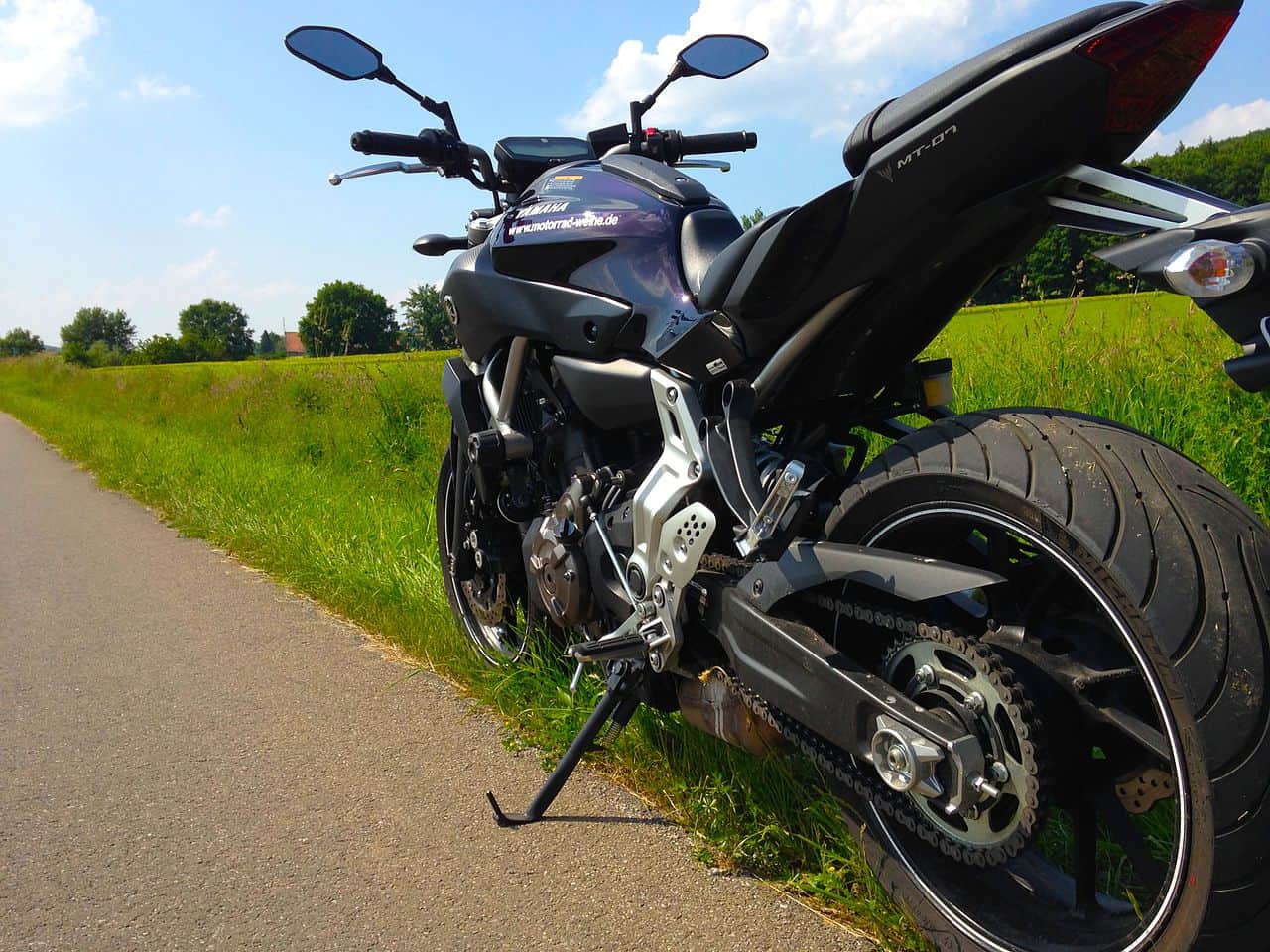 Yamaha MT-07 motorcycle parked on a country road under a clear sky