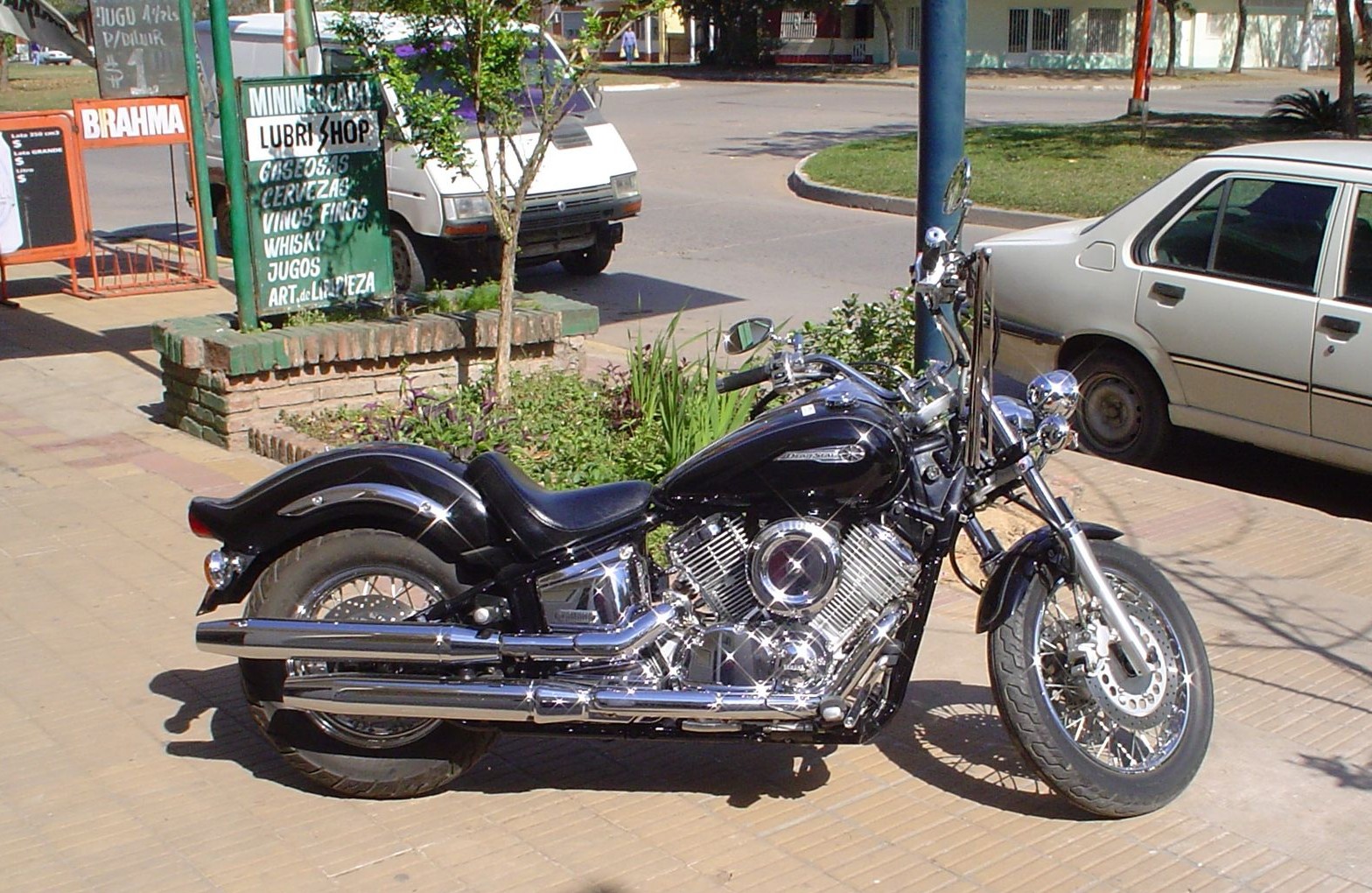 Yamaha DragStar 1100 parked in sunlight, showcasing its chrome details and classic cruiser lines