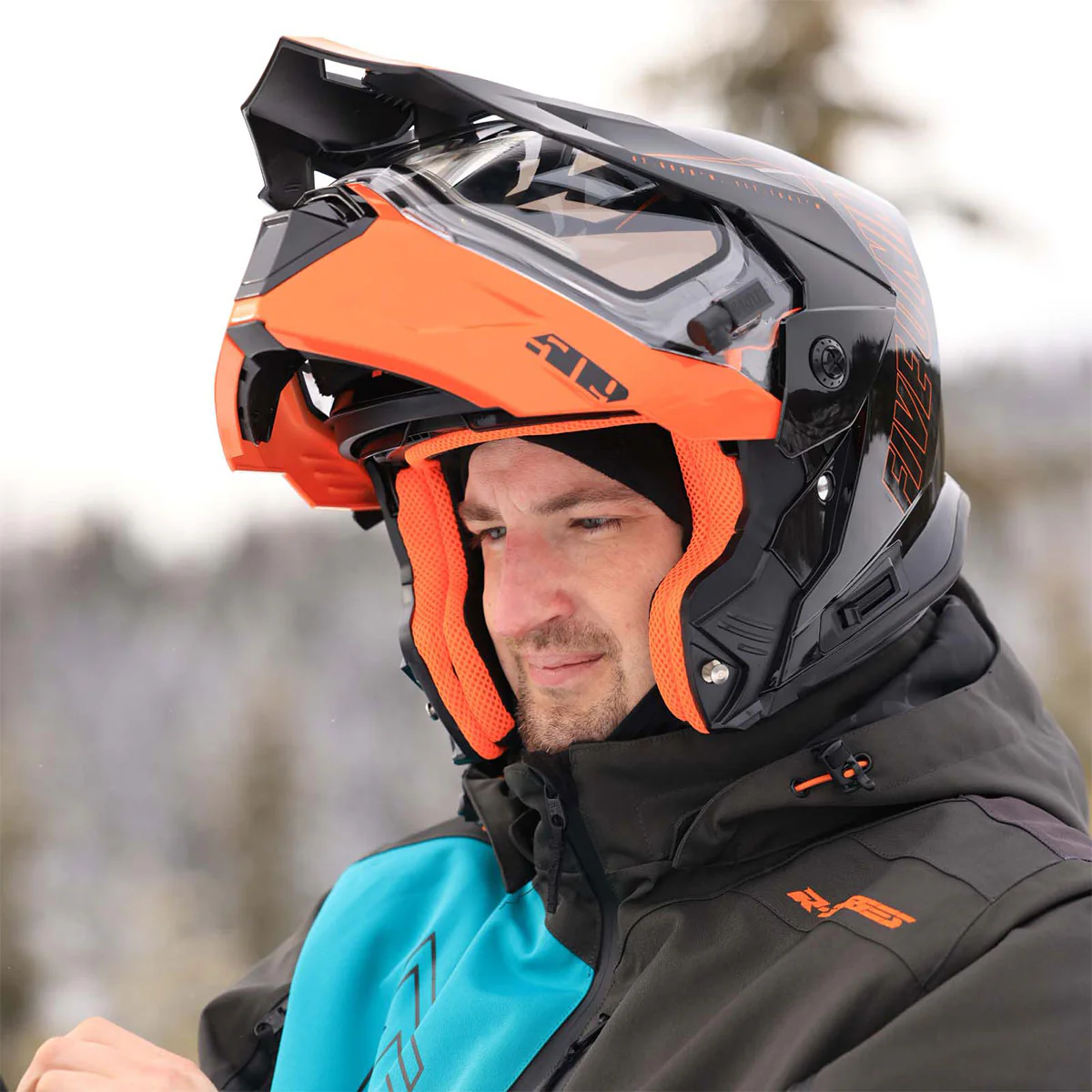 Snowmobiler wearing the 509 Delta R4 Ignite modular helmet with heated shield in cold-weather conditions