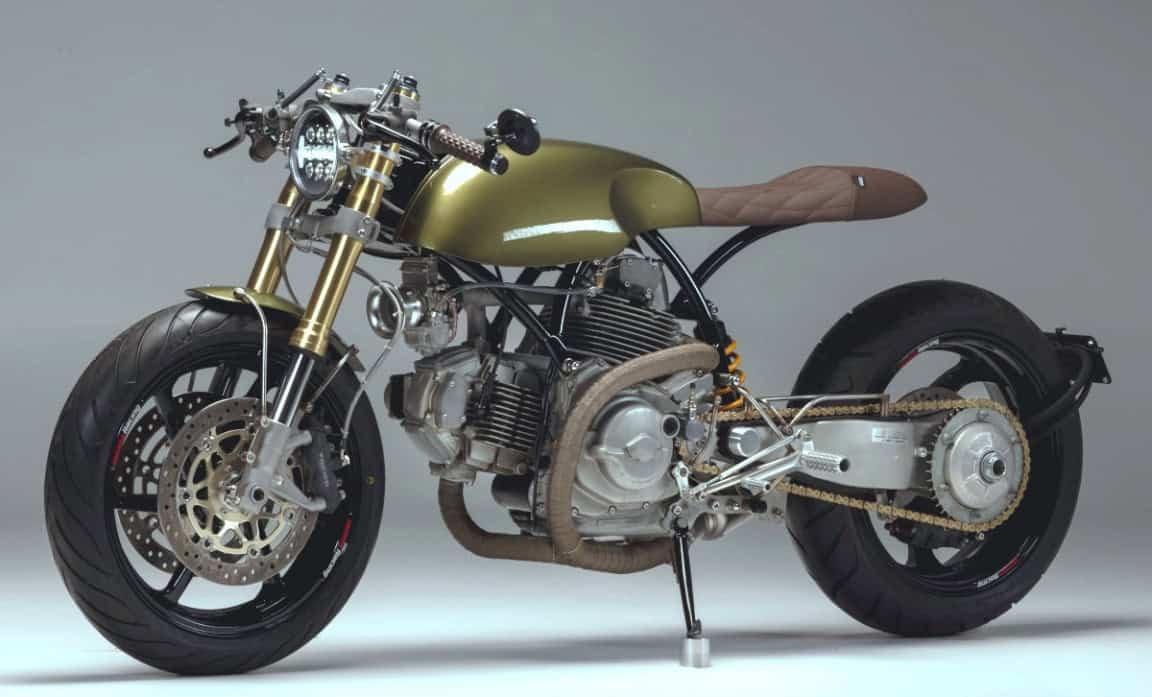 Custom café racer motorcycle with modified frame, brown seat, and performance upgrades