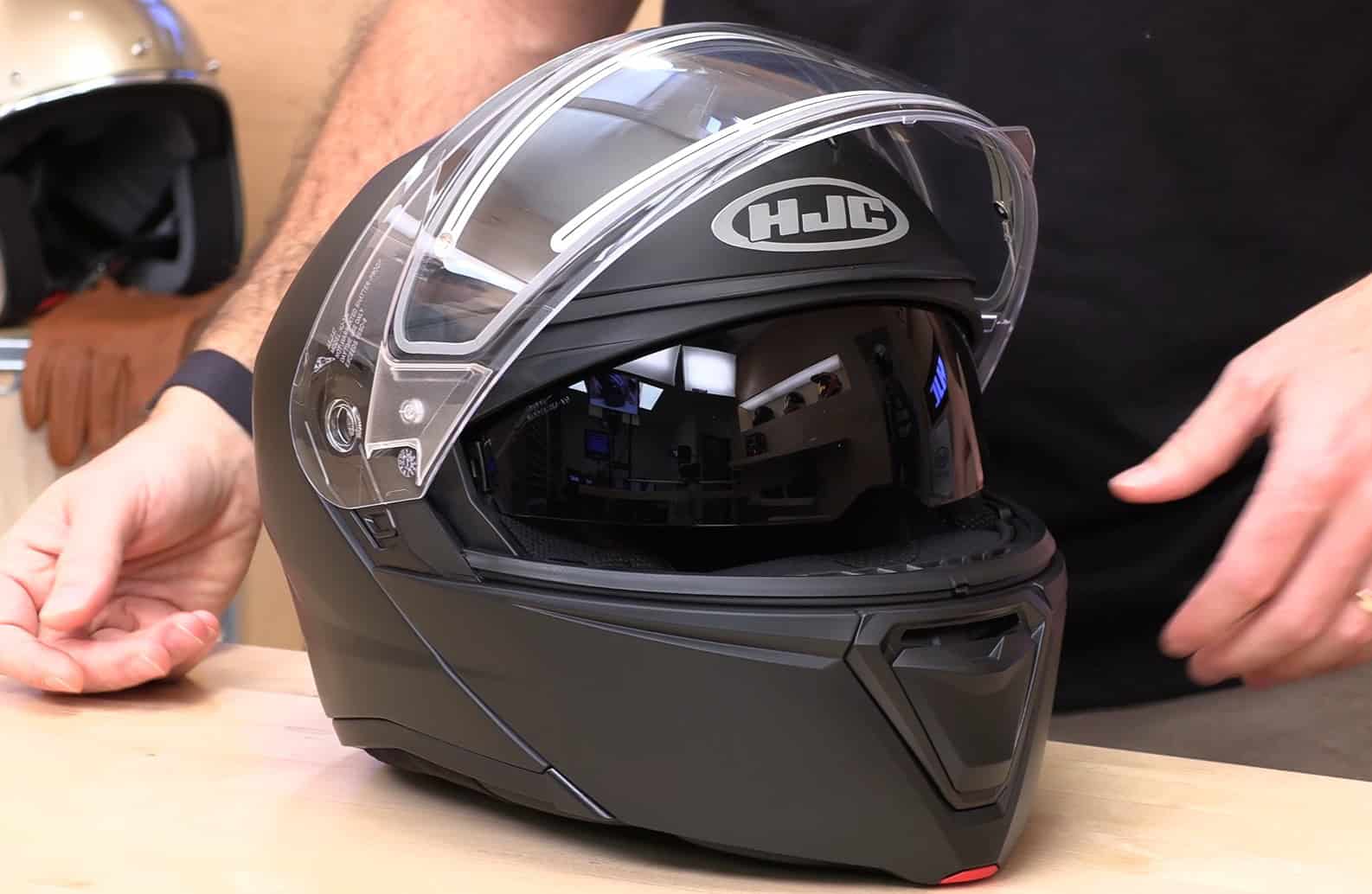 Close-up of the HJC i90 Electric modular snowmobile helmet with clear and tinted visors displayed