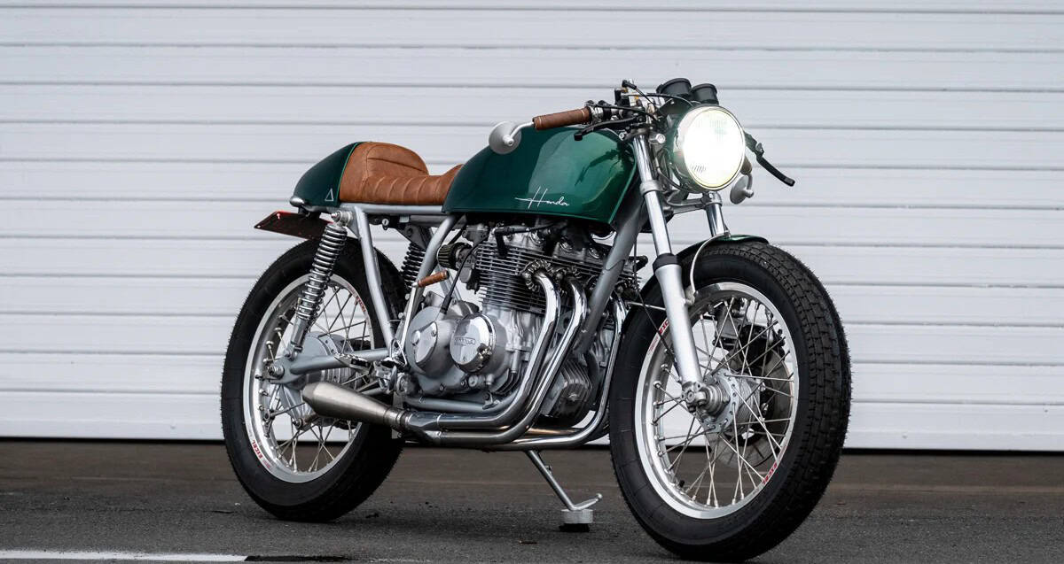 Custom green vintage café racer motorcycle with brown leather seat