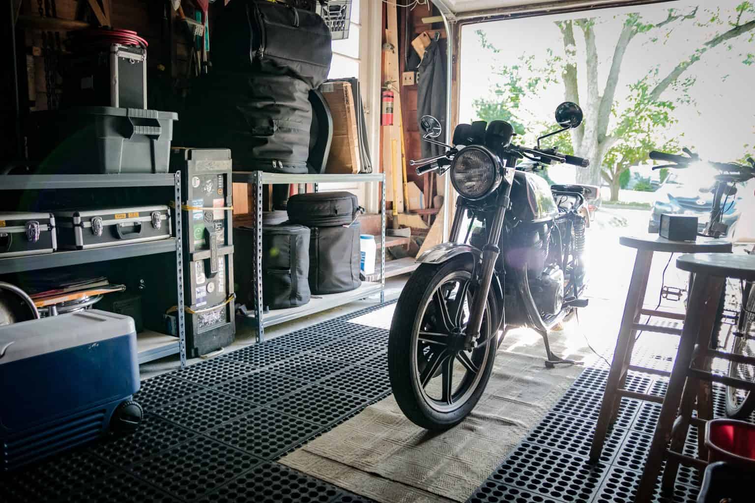 Motorcycle parked in a home garage with gear storage during deployment.