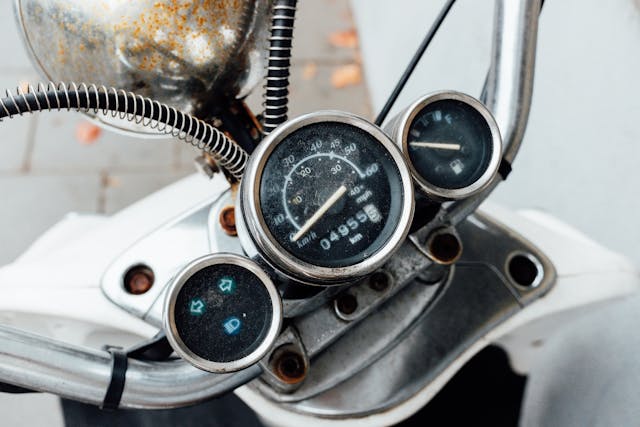 Close-up of a motorcycle odometer symbolizing mileage tracking for usage-based or pay-per-mile insurance savings.