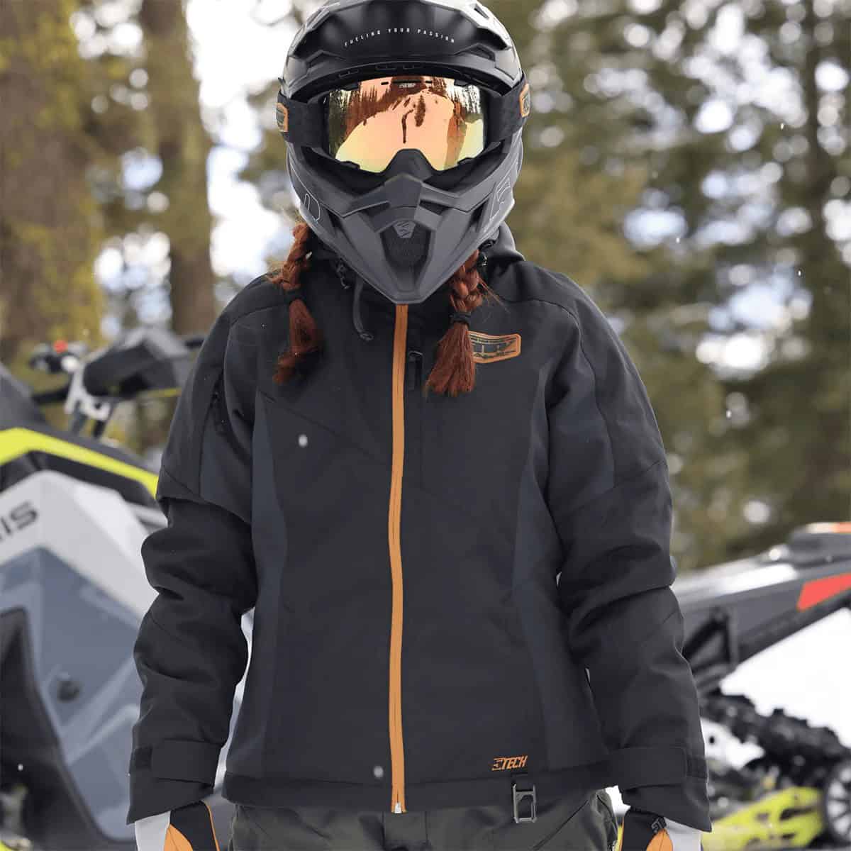 Woman wearing the 509 Women’s Range Insulated Jacket while snowmobiling in winter