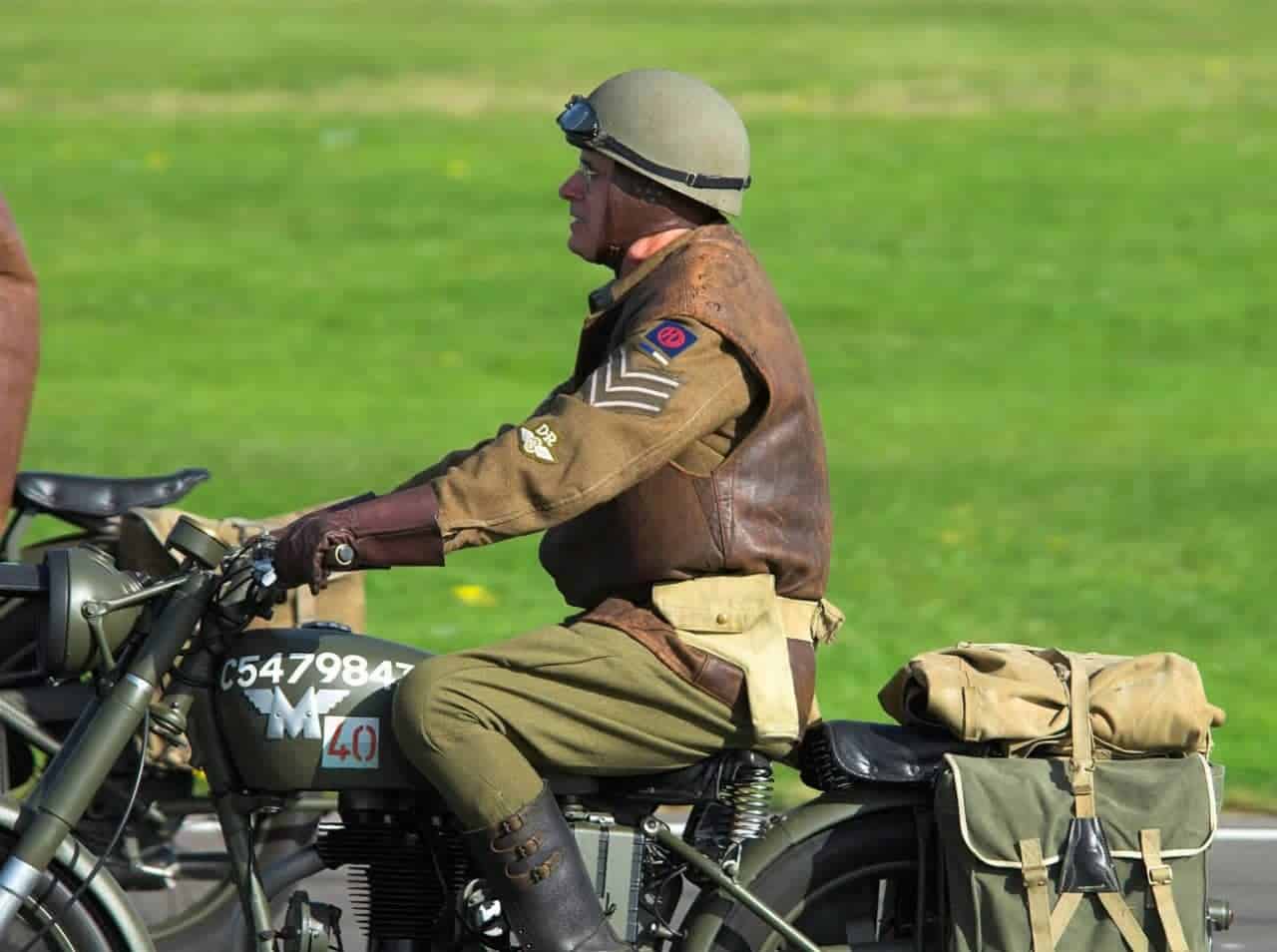 WWII-era soldier riding a classic military motorcycle, symbolizing Rider Insurance’s commitment to veterans and service members.