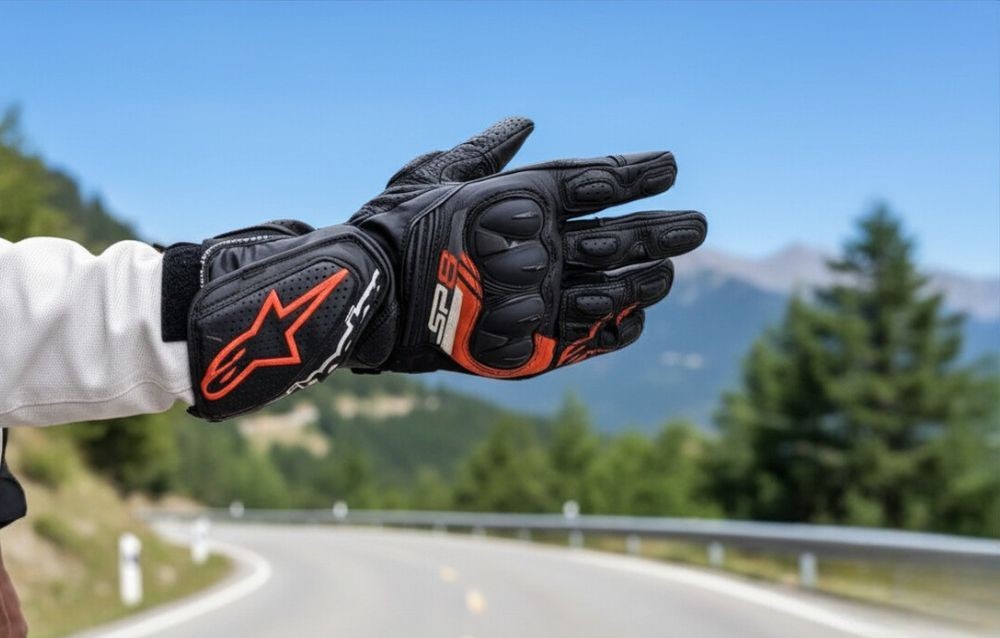 Alpinestars SP-8 V3 glove extended on road with mountains in background