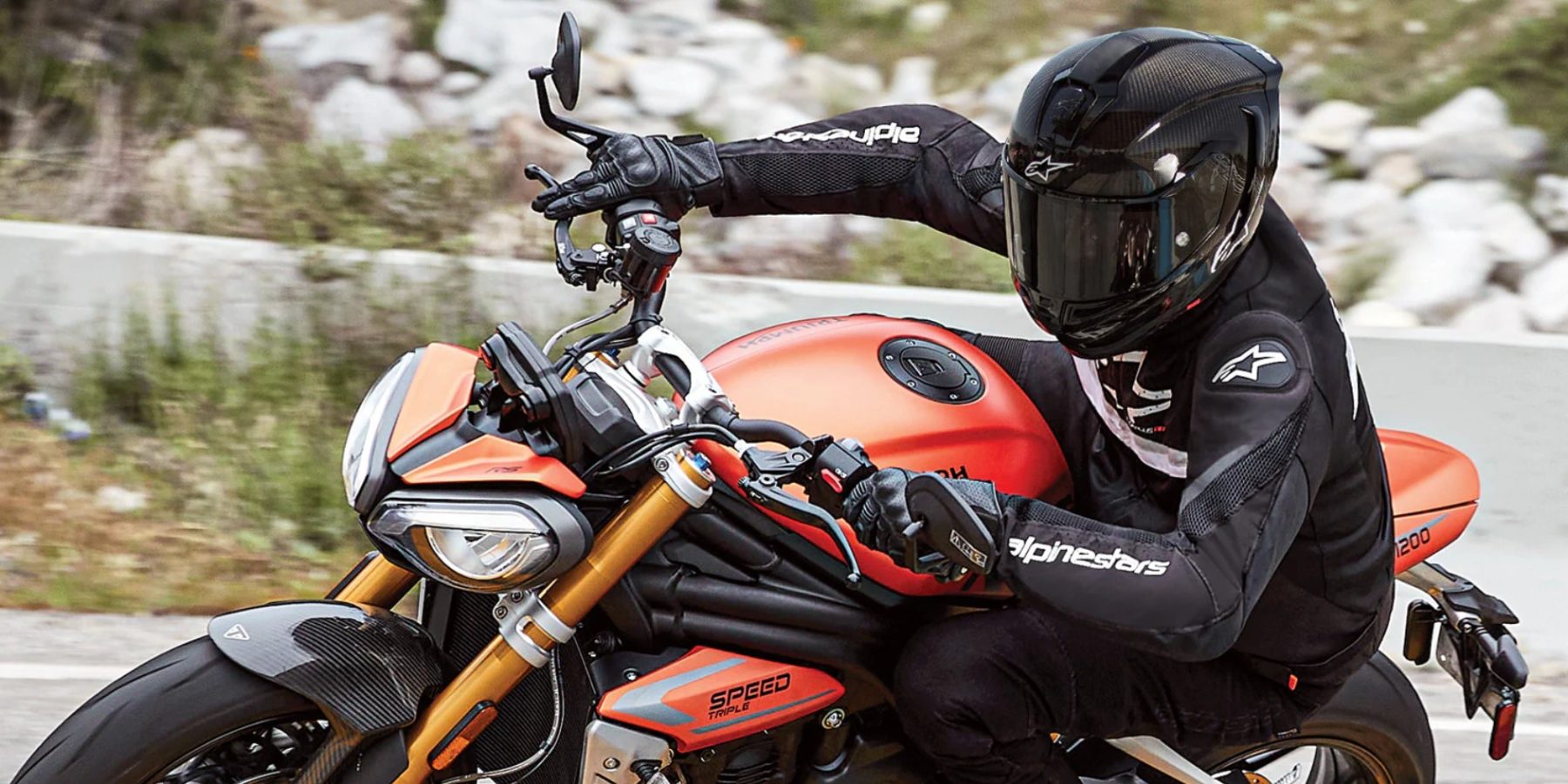 Rider wearing Alpinestars T-GP Plus R V4 Airflow jacket on a Triumph Speed Triple