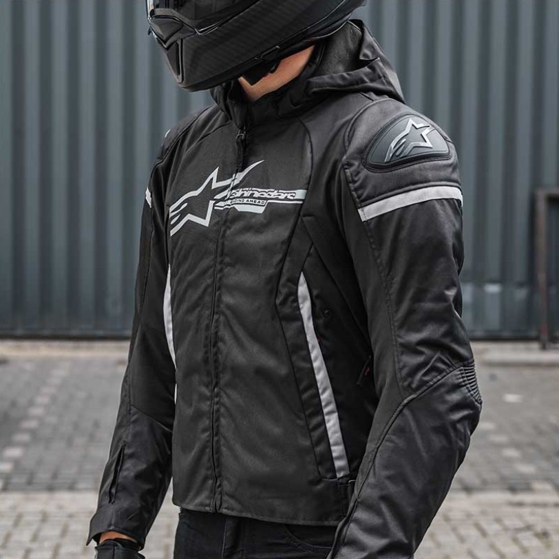 Rider wearing Alpinestars Zaca waterproof motorcycle jacket in black