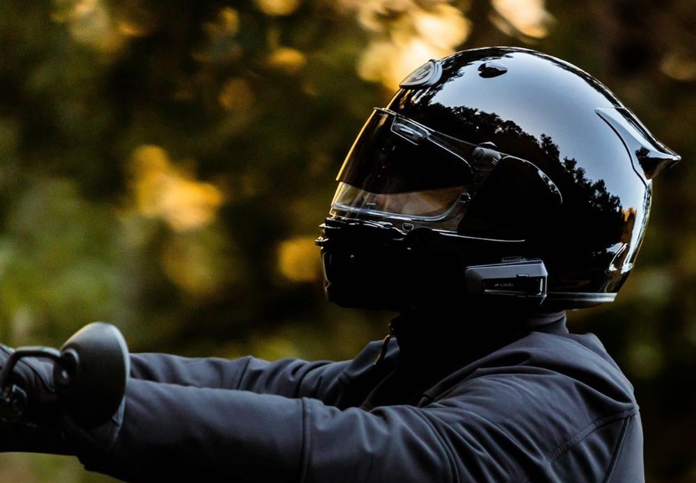 Rider wearing Arai Contour-X helmet with integrated communication system in motion