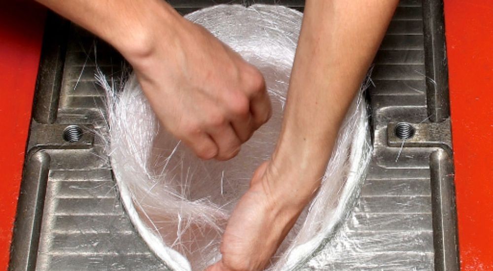 Fiberglass strands being layered for Arai PB-cLc helmet shell construction