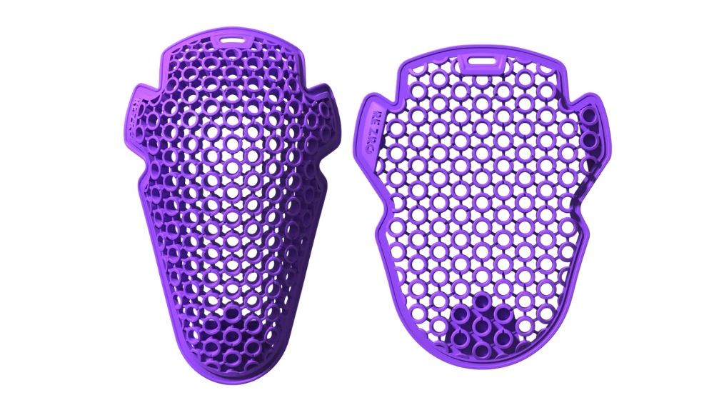 Purple motorcycle armor inserts with a ventilated honeycomb design used for knee or hip protection in riding gear