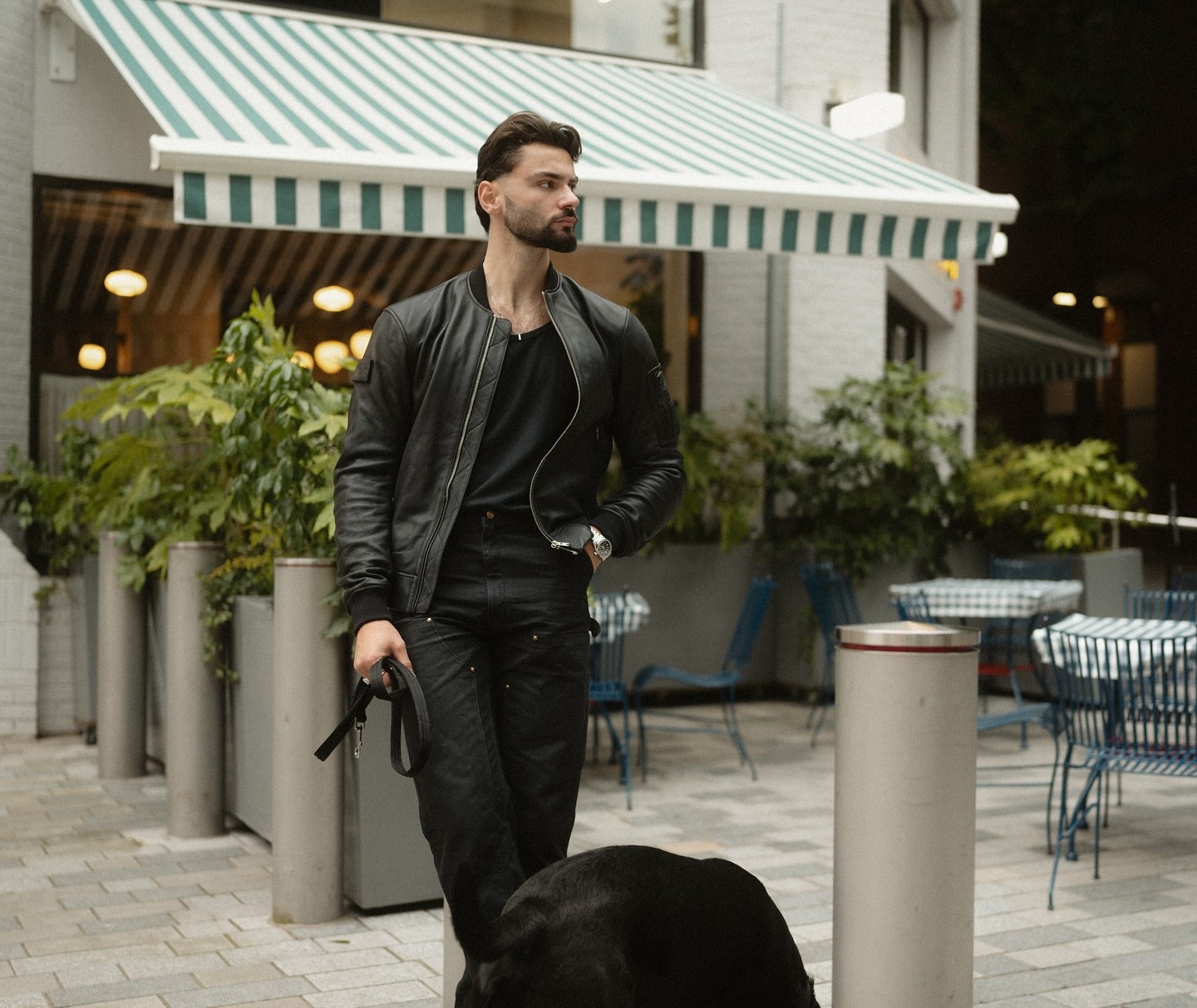 Rider wearing Pando Moto Falcon Aviator leather motorcycle jacket walking with a dog