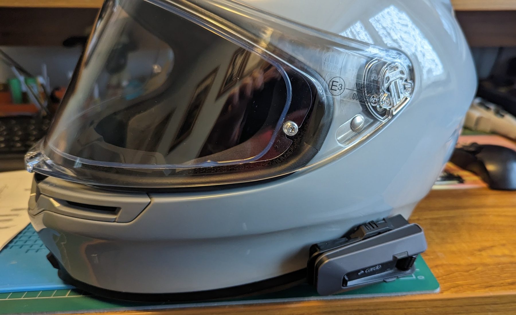 AGV K6 S helmet with mounted Cardo communication unit showing compact fitment