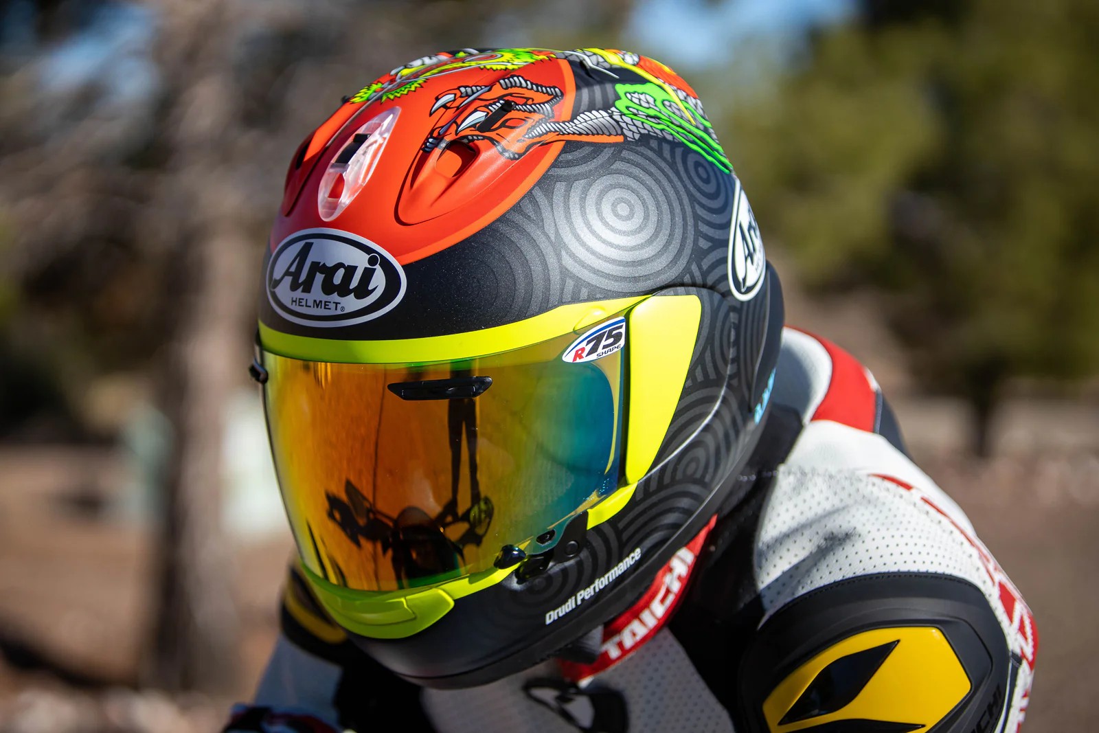 Rider wearing Arai Corsair-X helmet with tinted visor in a sport riding position