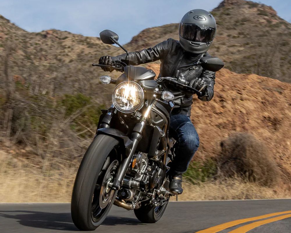 Rider wearing Arai Regent-X helmet riding on a canyon road