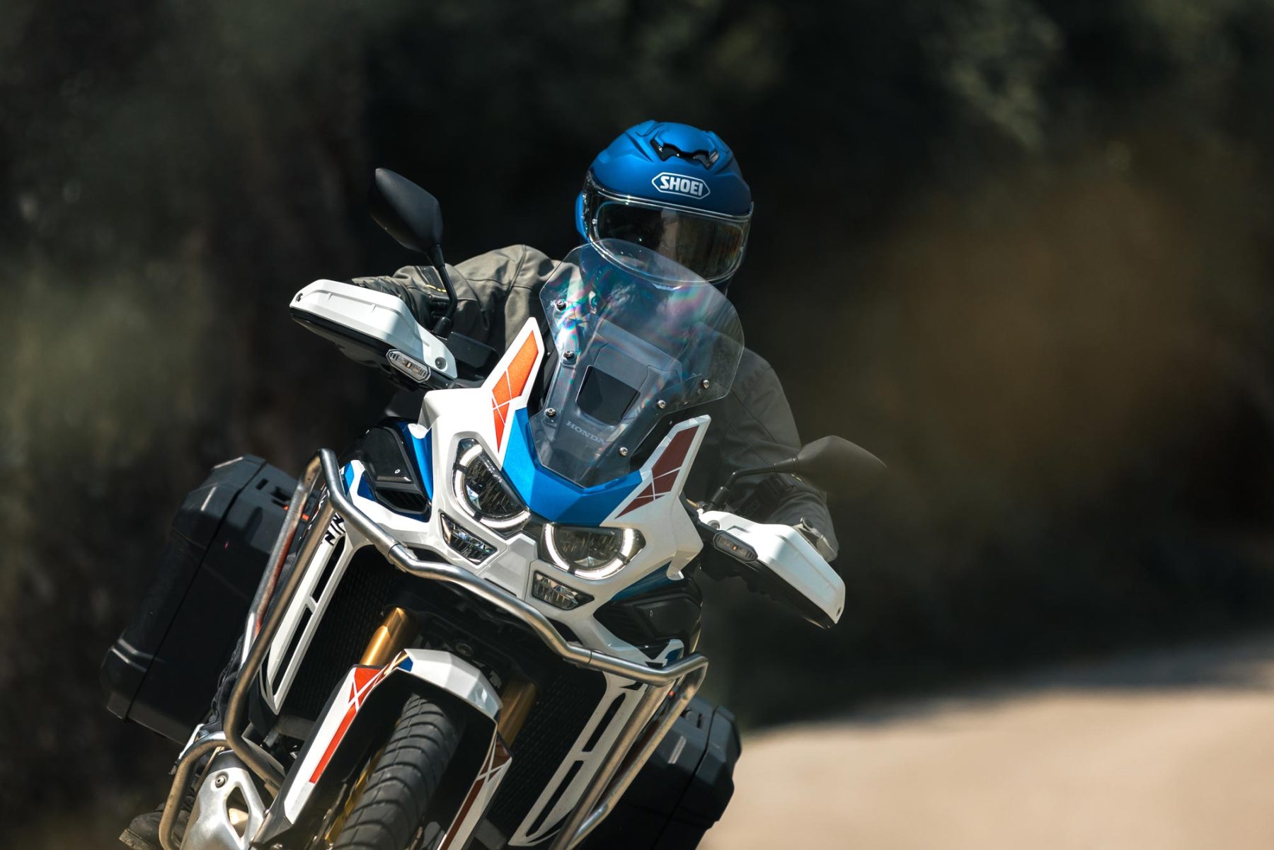 Rider wearing Shoei GT-Air 3 helmet on a touring motorcycle at highway speed