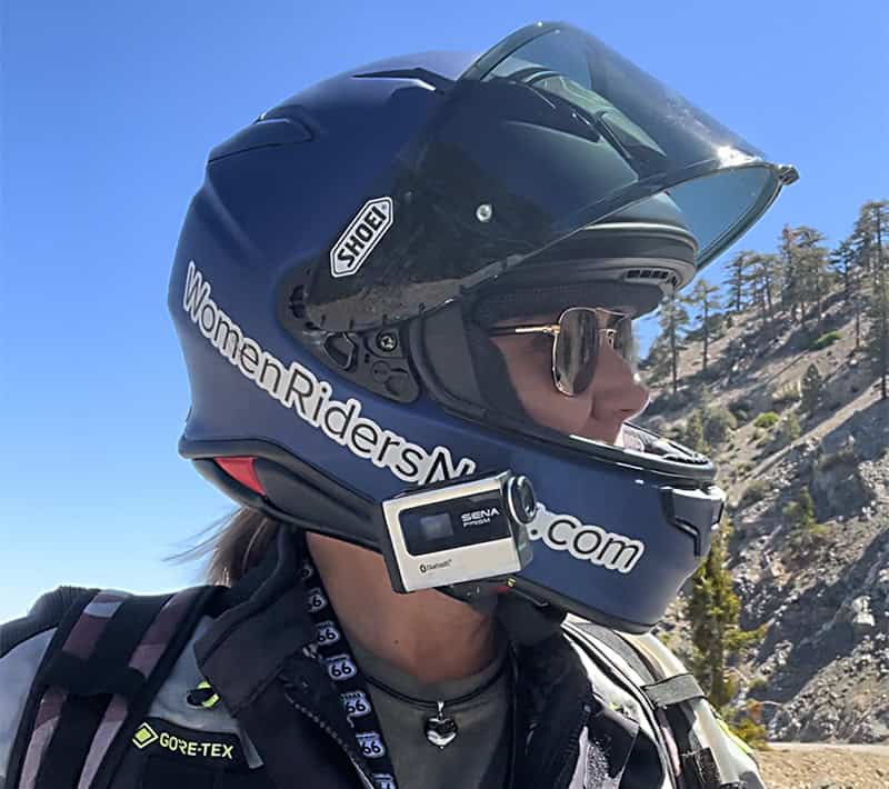 Rider wearing a Shoei RF-1400 helmet with glasses and a Sena communicator mounted on the side