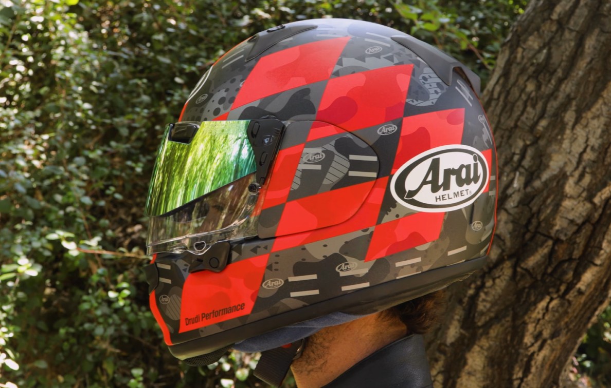 Arai Regent-X full-face helmet with red camo graphic and mirrored visor worn outdoors